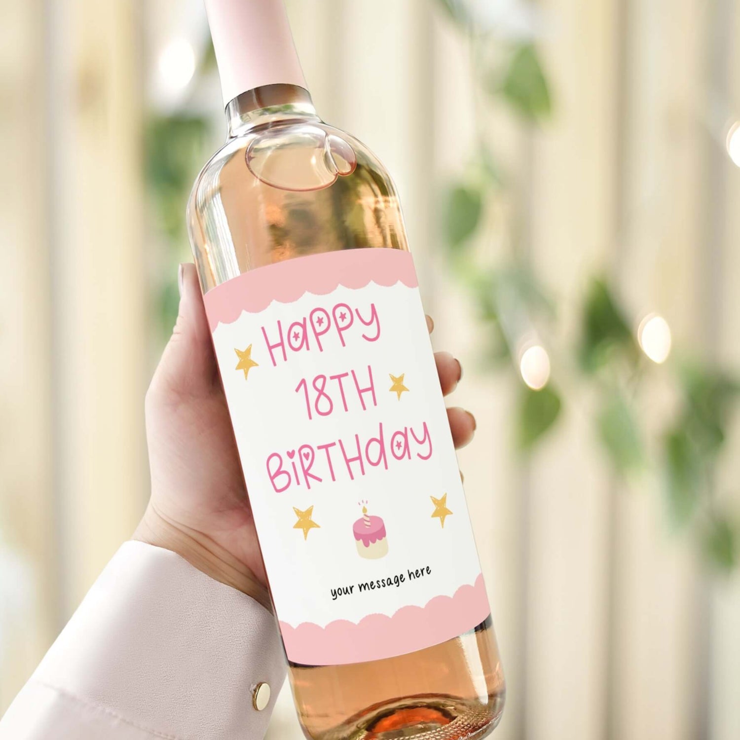Custom wine label for an 18th birthday gift featuring pink text, stars, and a cake illustration on a wine bottle.