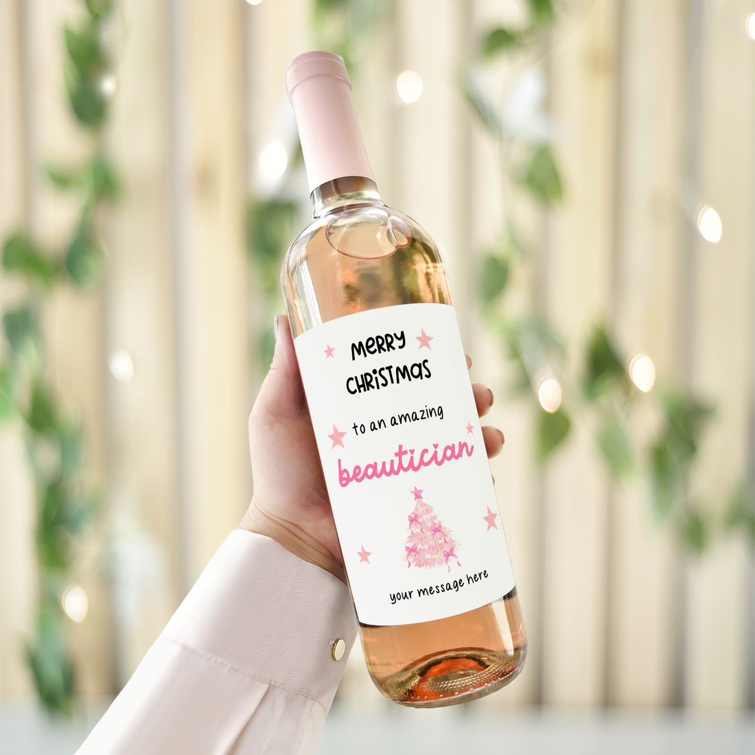 Personalised Christmas wine bottle label for beautician with pink festive design and custom message option.