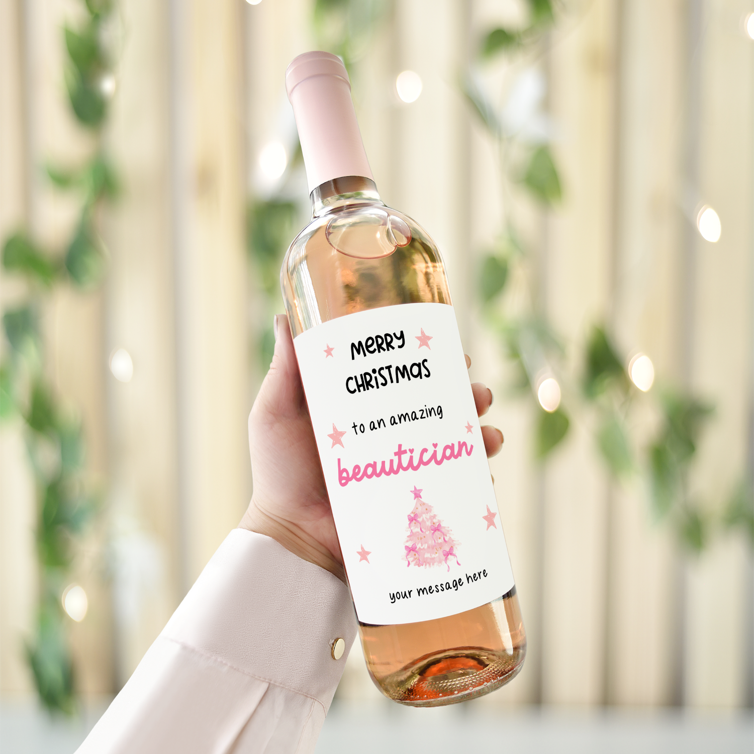 Personalised Christmas wine bottle label for beautician with pink festive design and custom message option.