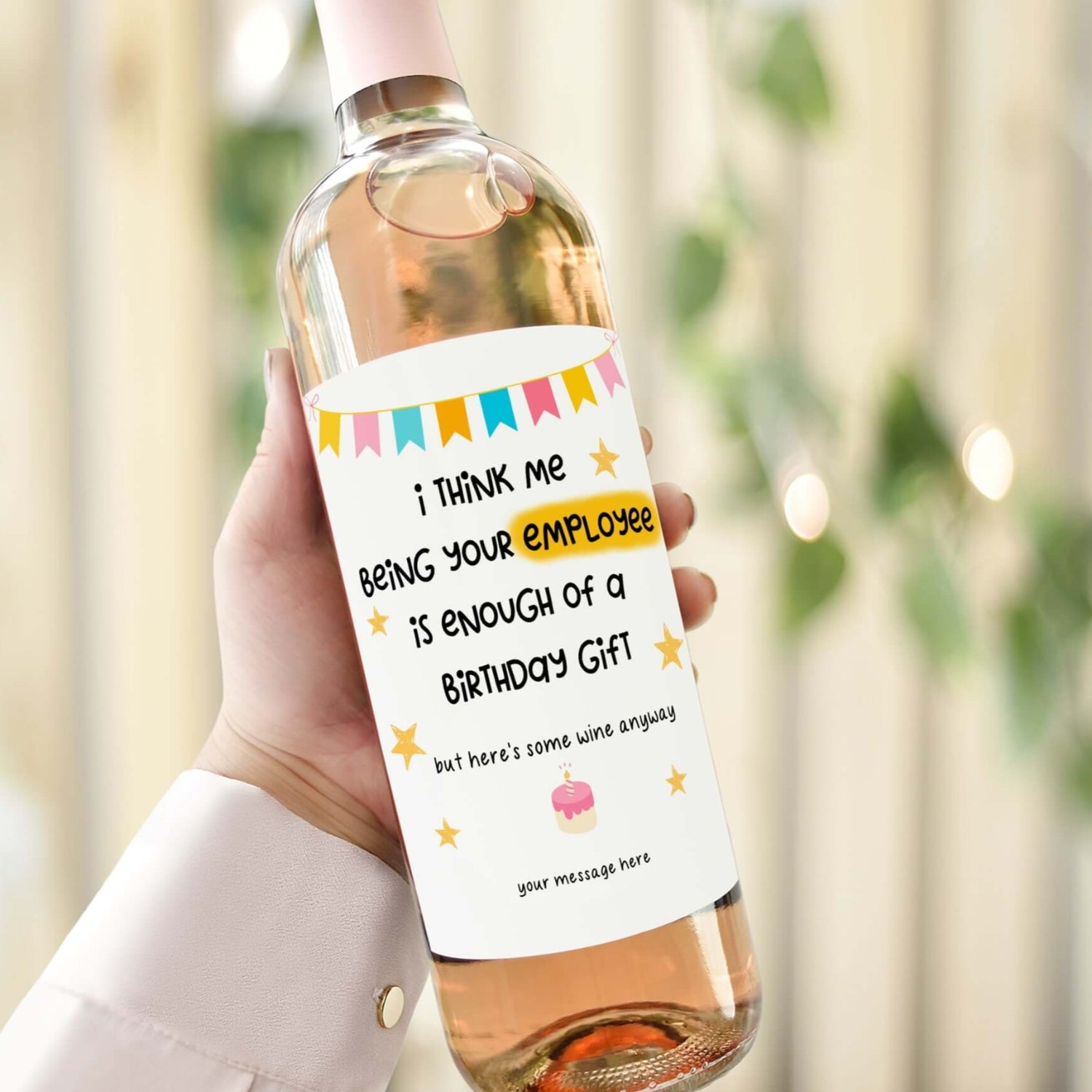A wine bottle with a birthday label reading "I think me being your employee is enough of a birthday gift, but here’s some wine anyway.