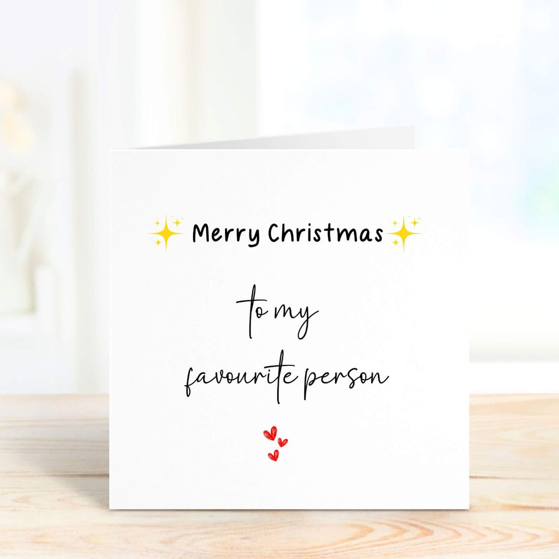 Personalised Christmas card with the message "Merry Christmas to my favourite person" featuring festive star icons and red hearts. Ideal for gifting to a loved one.