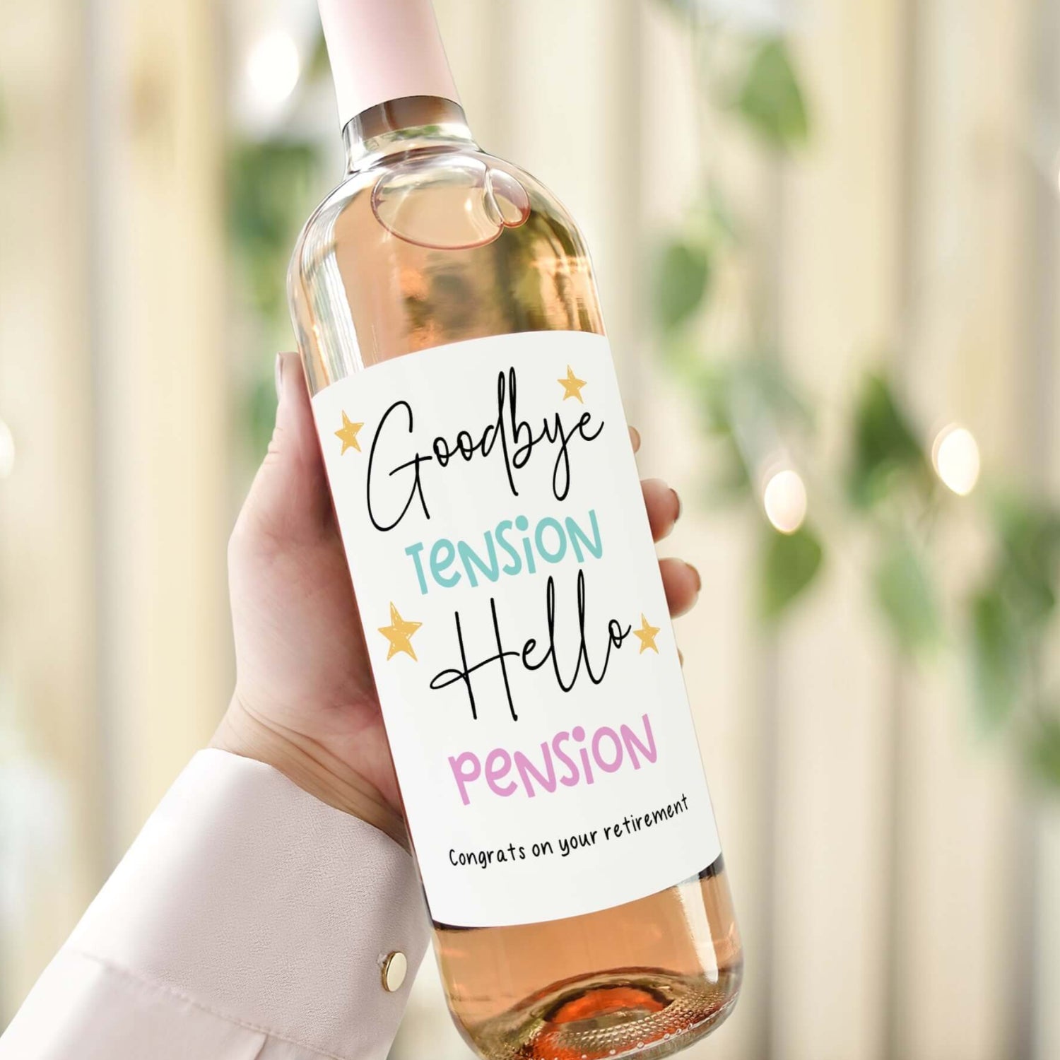 Wine bottle with a funny retirement label reading "Goodbye Tension, Hello Pension," ideal for a lighthearted and unique retirement gift.
