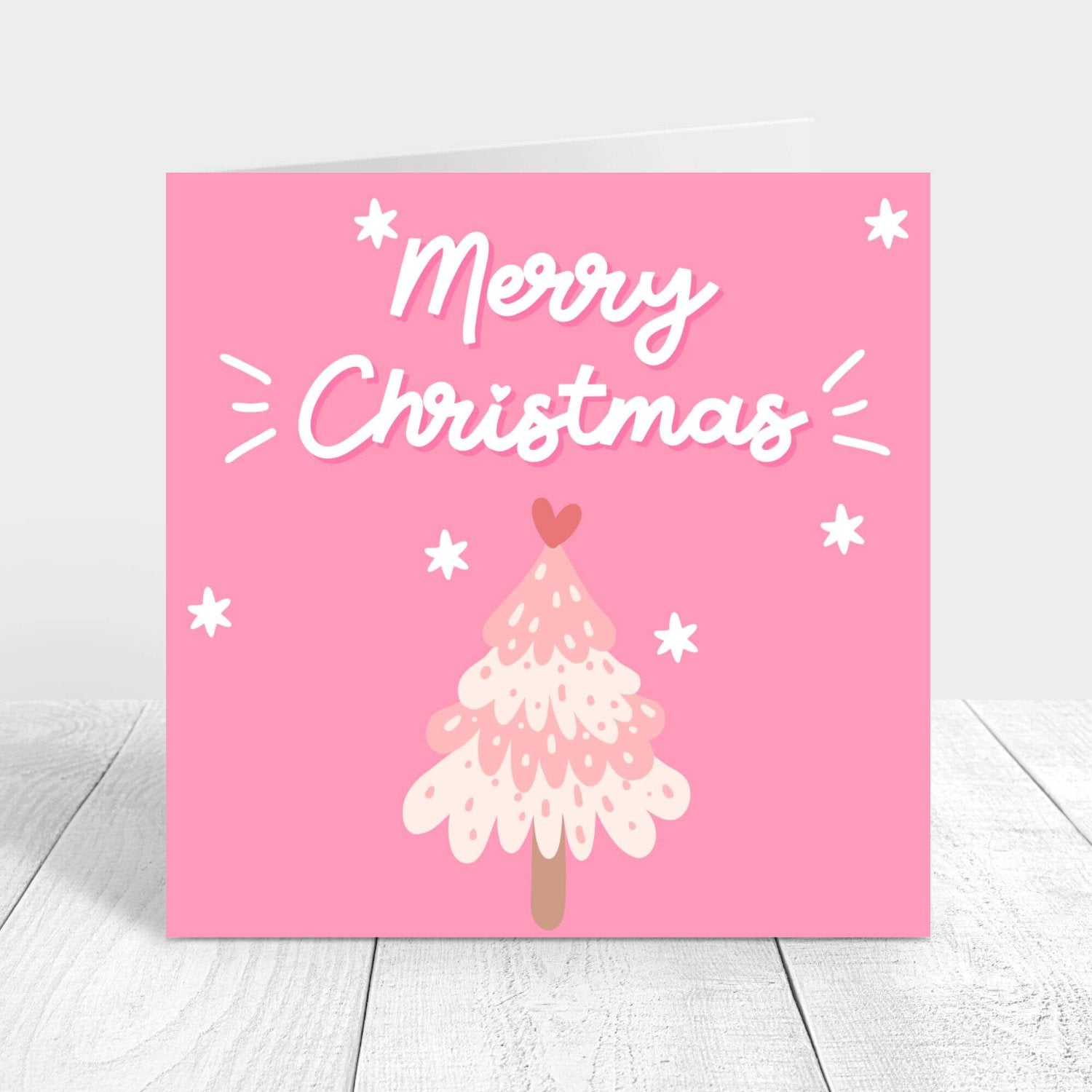 Merry Christmas card with pink background and a light pink christmas tree