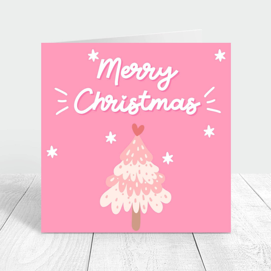 Merry Christmas card with pink background and a light pink christmas tree