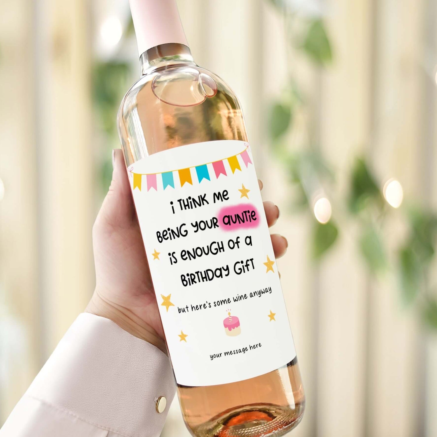 A wine bottle with a birthday label reading "I think me being your auntie is enough of a birthday gift, but here’s some wine anyway."
